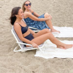 Two women chatting on the beach