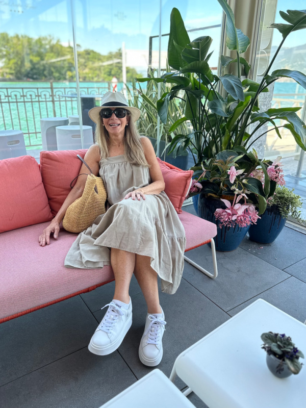 Woman sitting on sofa in Lake Iseo hotel.