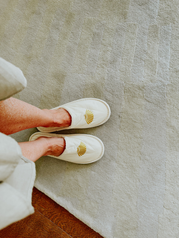 Woman wearing Mandarine Oriental spa slippers.