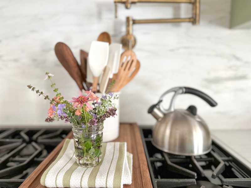 Flower bouquet sitting on range top.