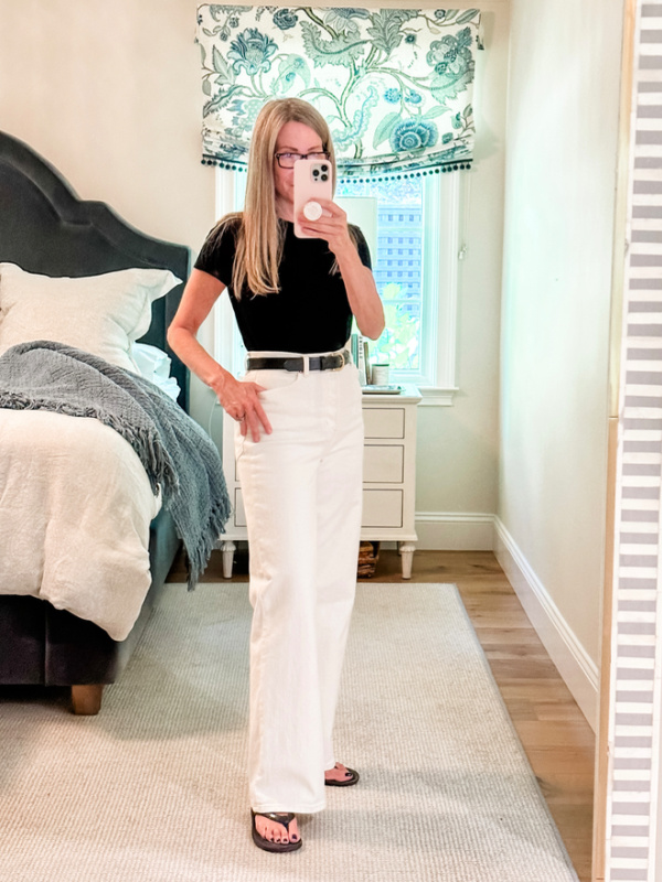 Woman taking mirror selfie.