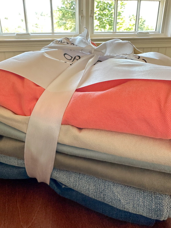 Stack of pants tied with white ribbon.