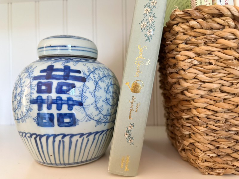 The Secret Garden propped up on bookshelf.