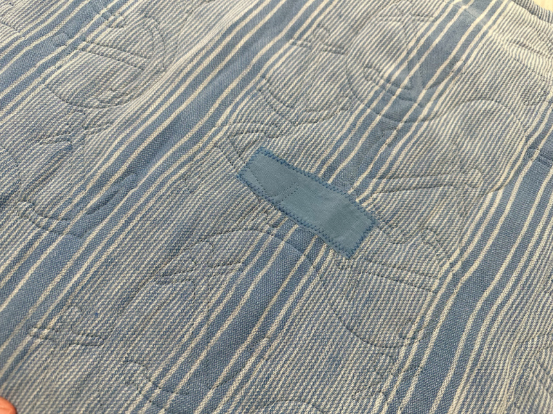 Patch on striped blanket.