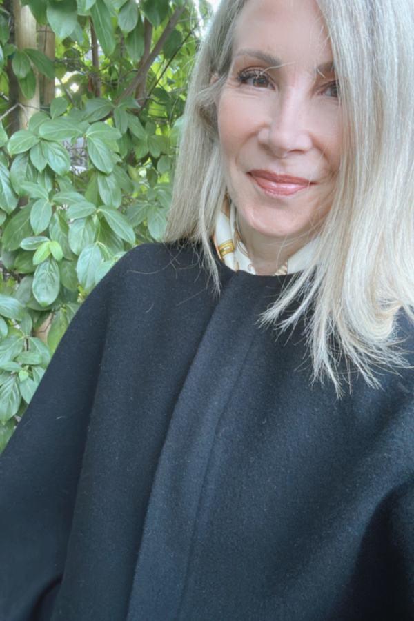 Woman wearing Hermes scarf and Ralph Lauren Purple Label coat.