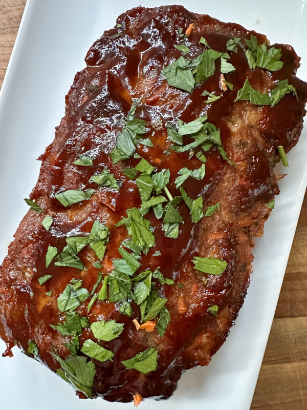 Meatloaf on a white platter.