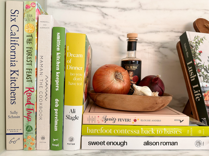 Cookbooks and produce on kitchen counter.