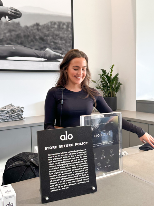 Woman at Alo cash register.