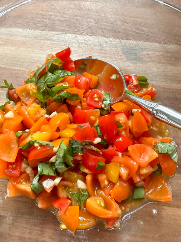 Chopped tomatoes and basil in bowl.