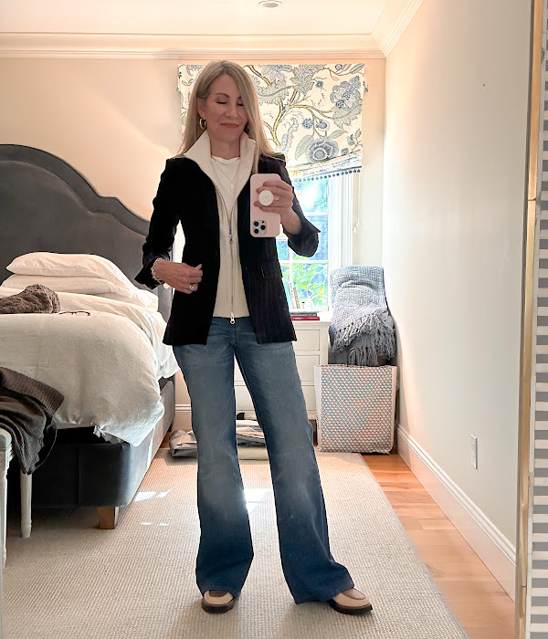 Woman wearing Veronica Beard blazer with dickie, and jeans taking mirror selfie.