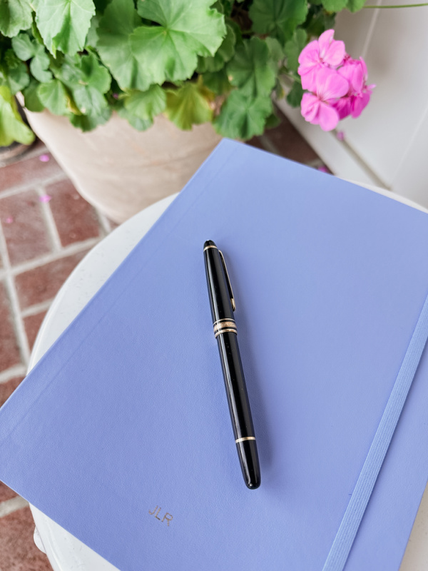 Moleskine journal and Montblanc pen.