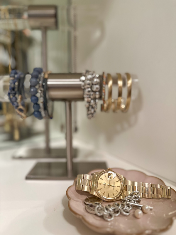 Jewelry tray and stands on vanity top.