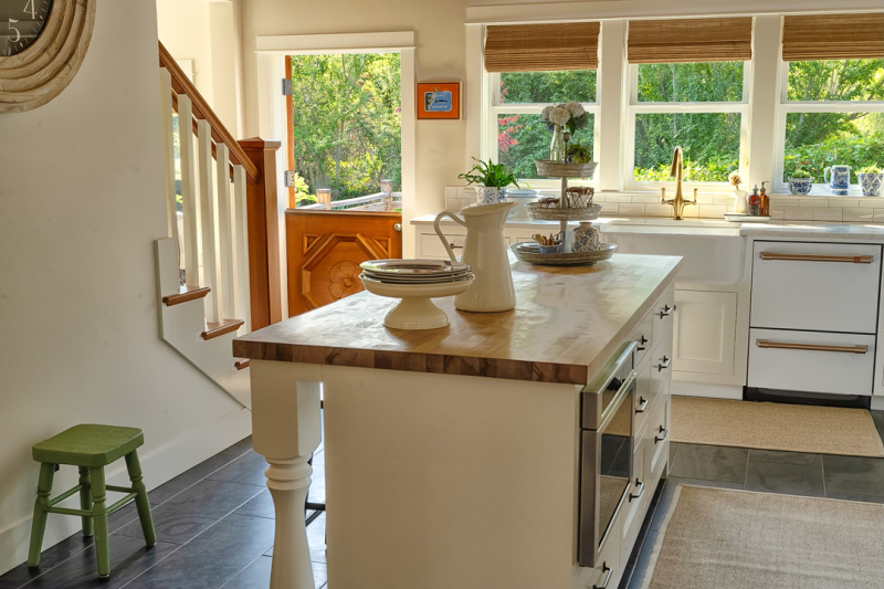 Kitchen island look back toward stairs in pretty island home.