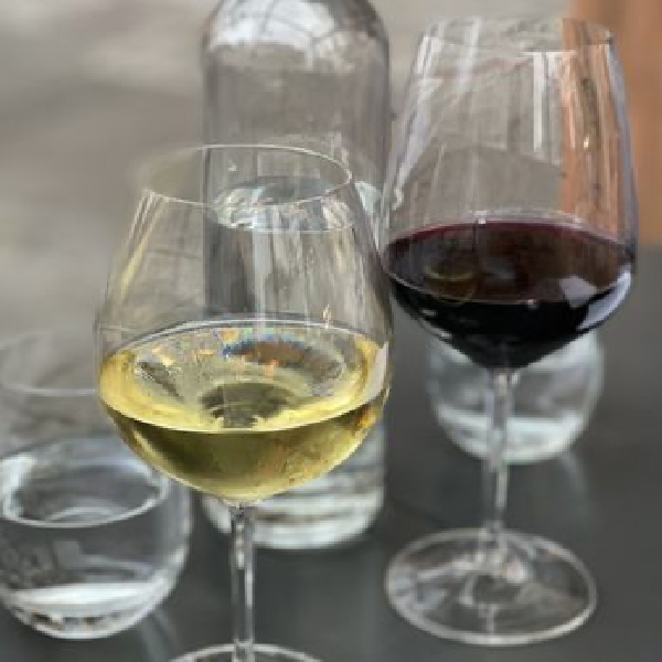 Cultivar SF wine glasses and water bottle on dining table.