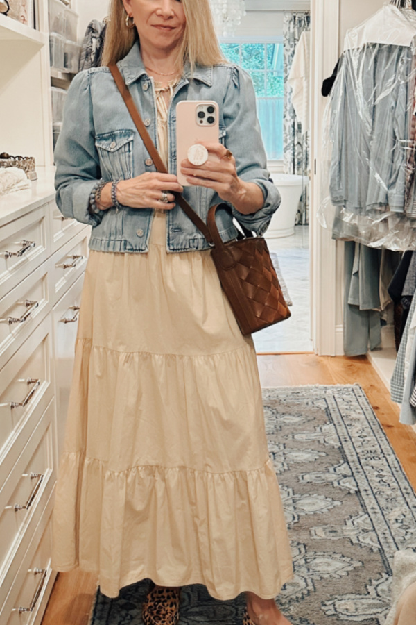 Woman taking closet selfie showing off J.Crew woven bucket bag.