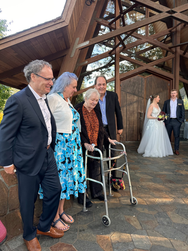 Family outside wedding chapel with bride and groom.