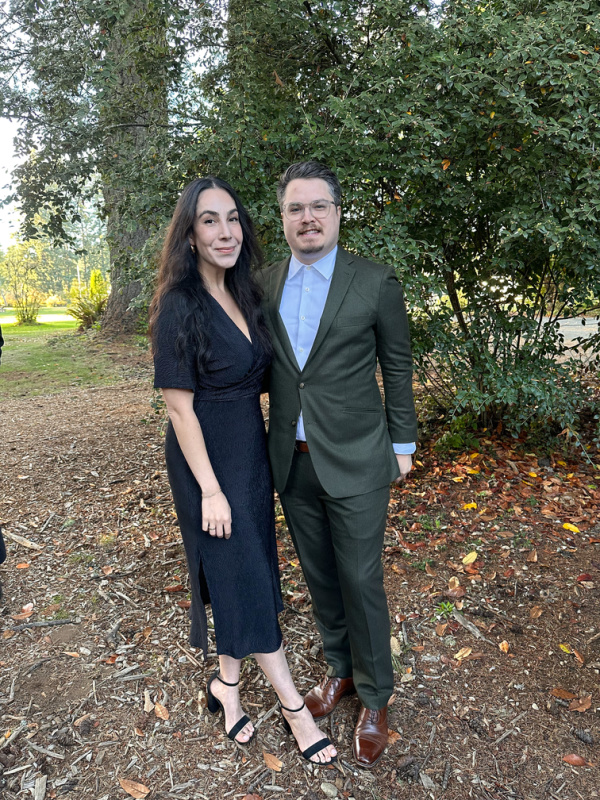 Couple standing outside wedding chapel.