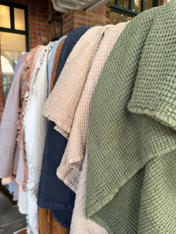 Upper East Linens fall colors on rack.