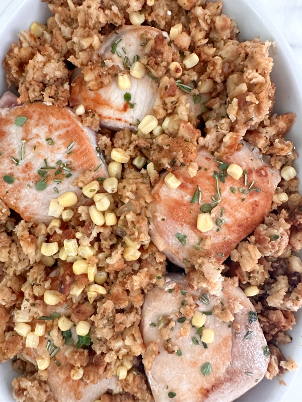 Pork chops and stuffing in baking pan.