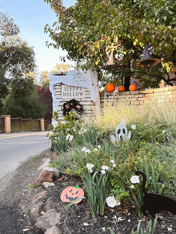Sleepy Hollow neighborhood entrance pillar decorated for Halloween.