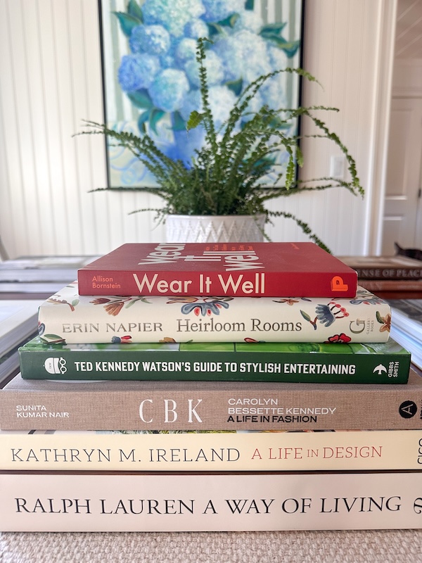Stack of decor books on table.