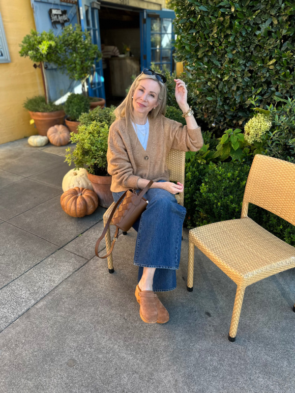 Woman sitting in front of Angele restaurant in Napa.