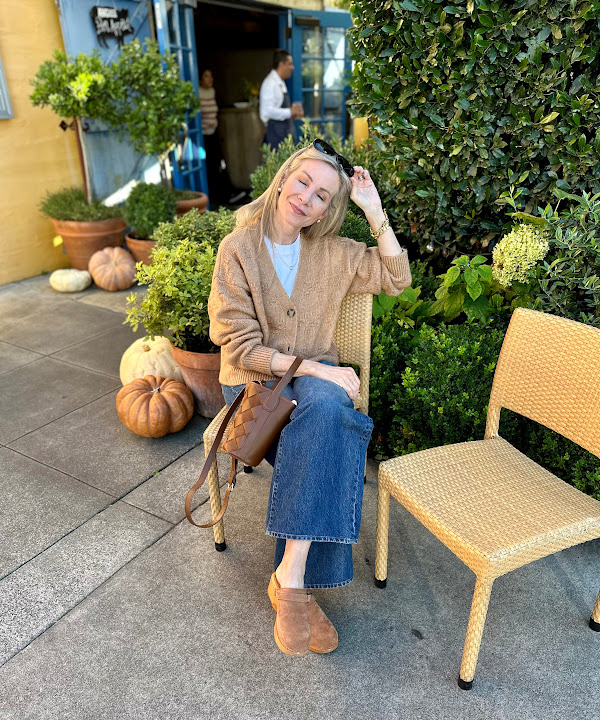 Woman sitting in chair outside Angele in Napa.