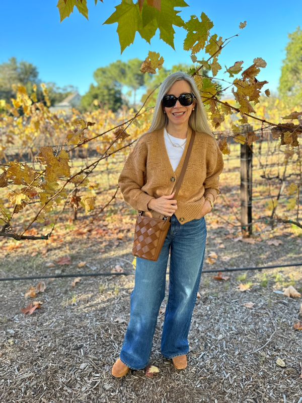 Woman standing in vineyard.