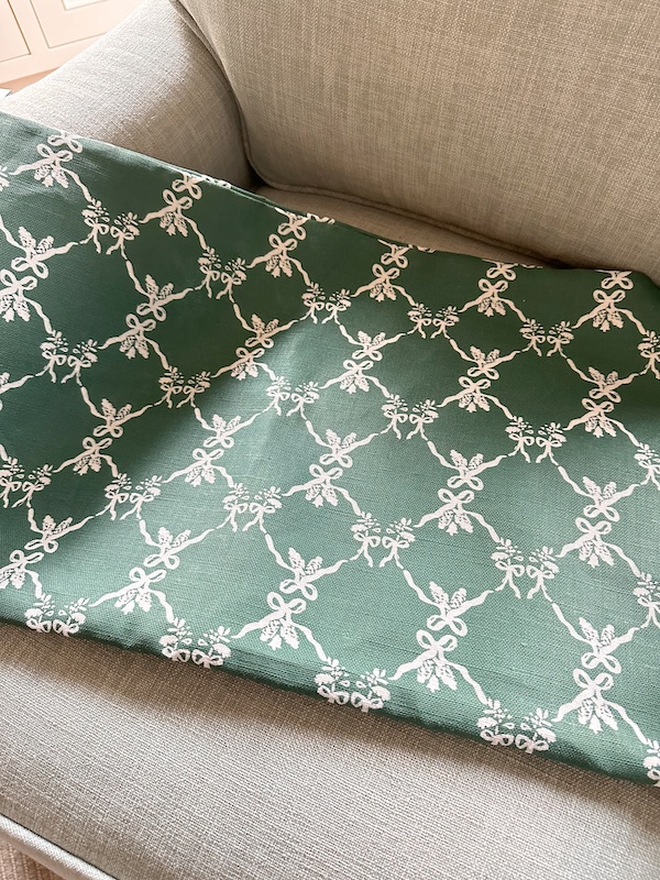 Jansen Home holiday bow pillow cover on chair.