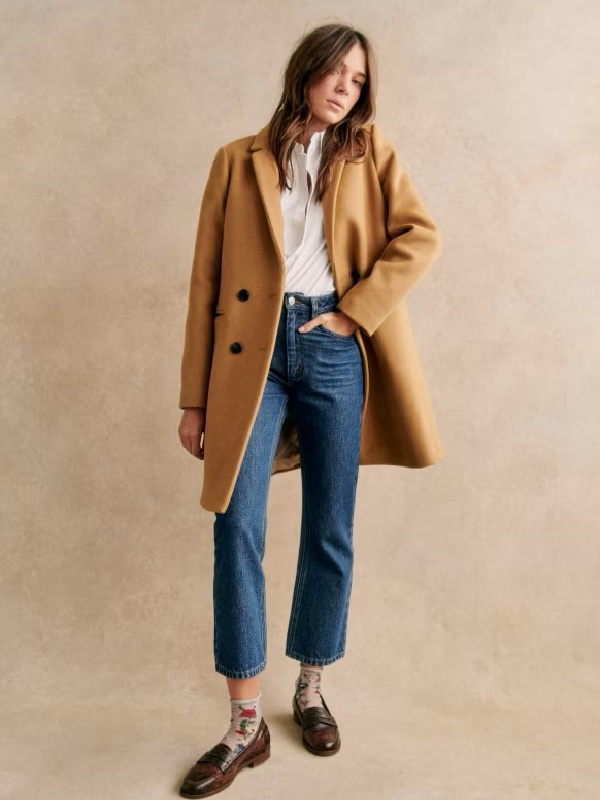 Model wearing Sezane camel coat.