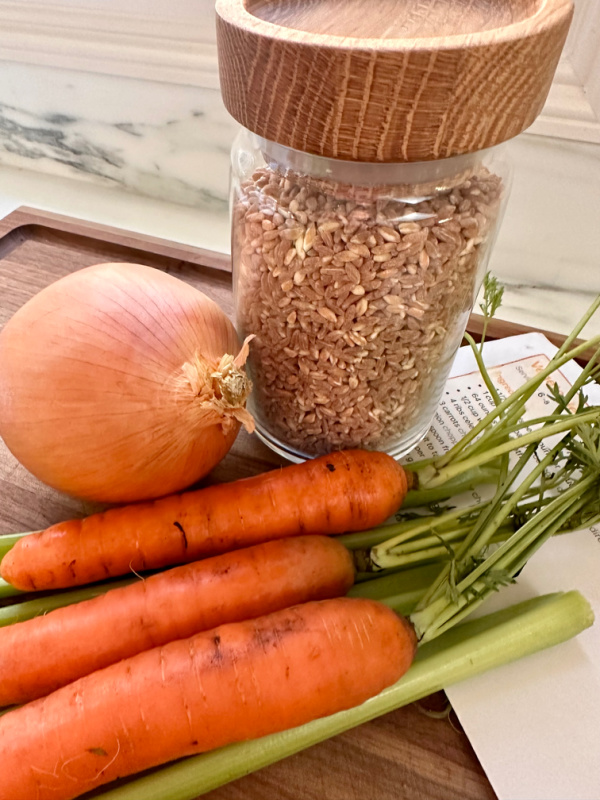 Ingredients for vegetable beef soup with farro on cutting board.