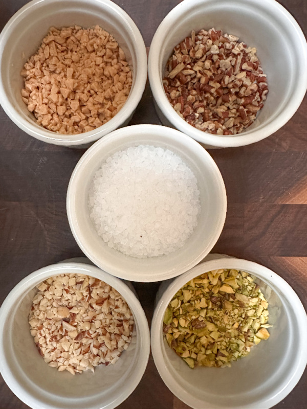 Five ramekins of chopped Christmas Cookie toppings.