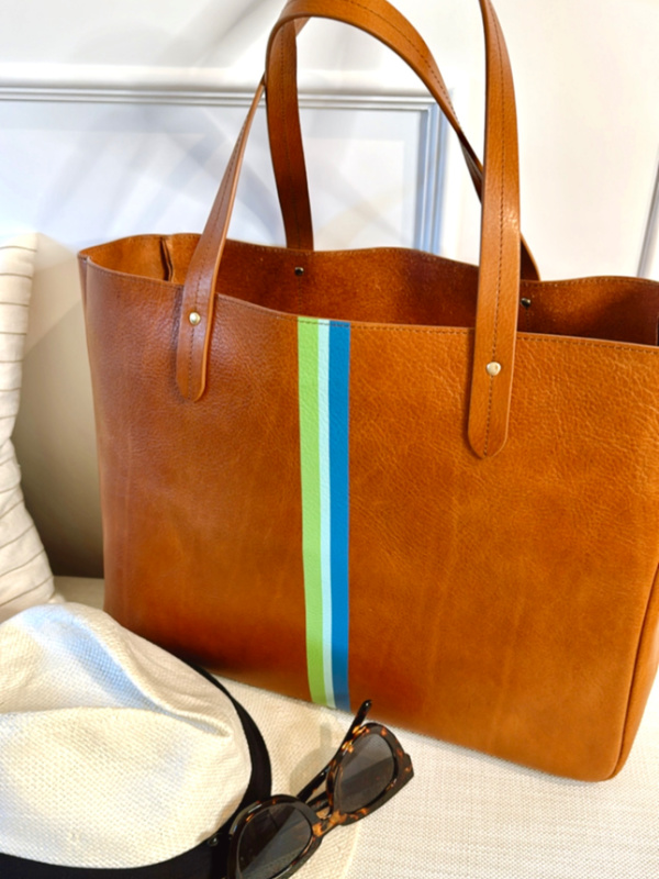 Ivy Cove East West tote sitting on bench next to hat and sunglasses.