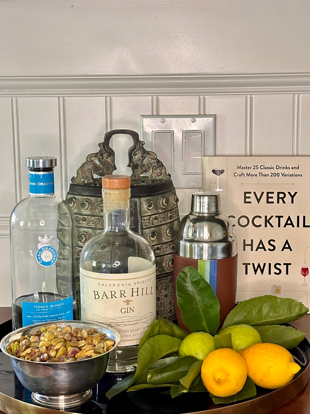 Every Cocktail Has a Twist book propped up on bar.