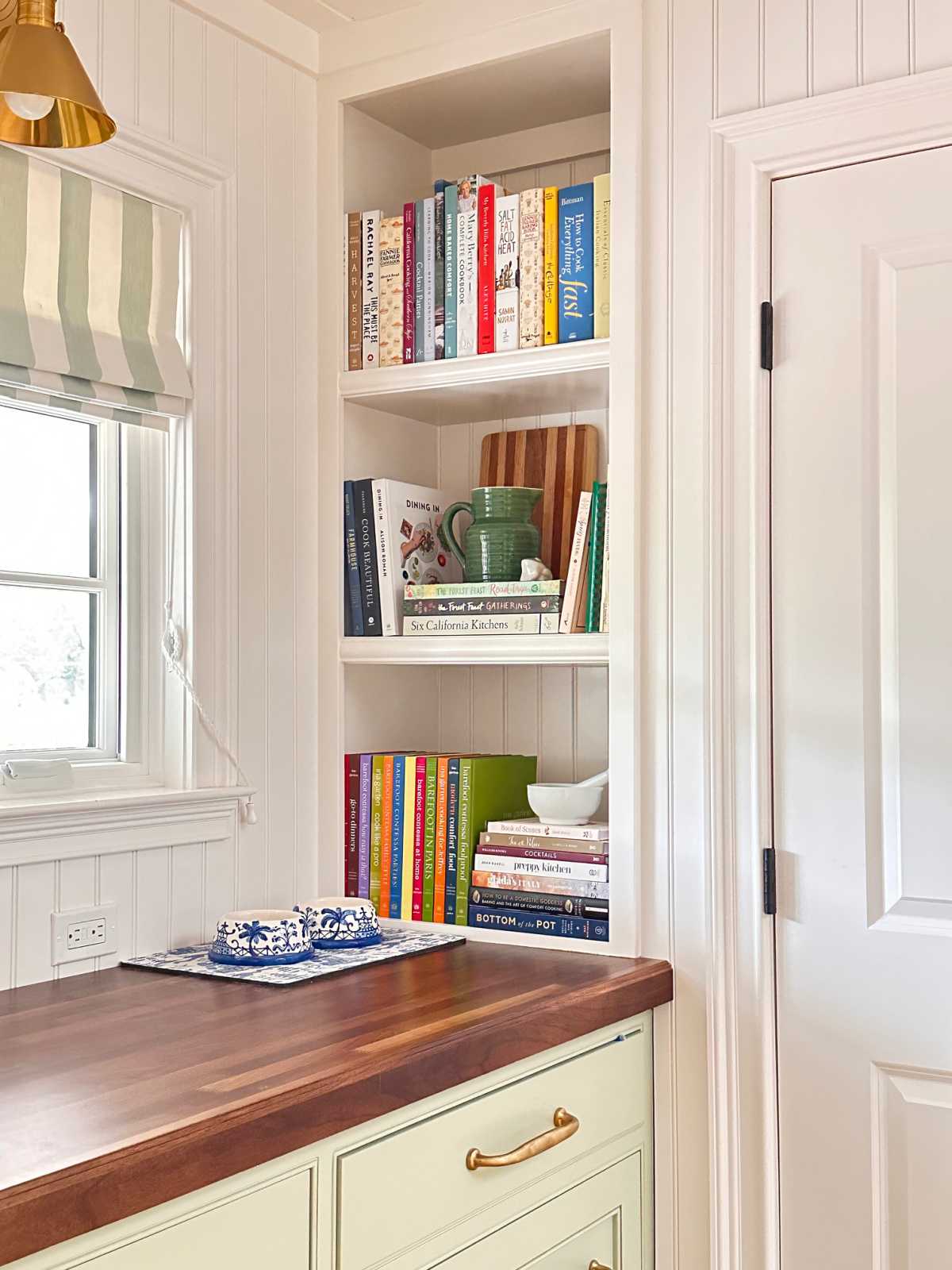 Cookbook shelve nook on kitchen countertop.