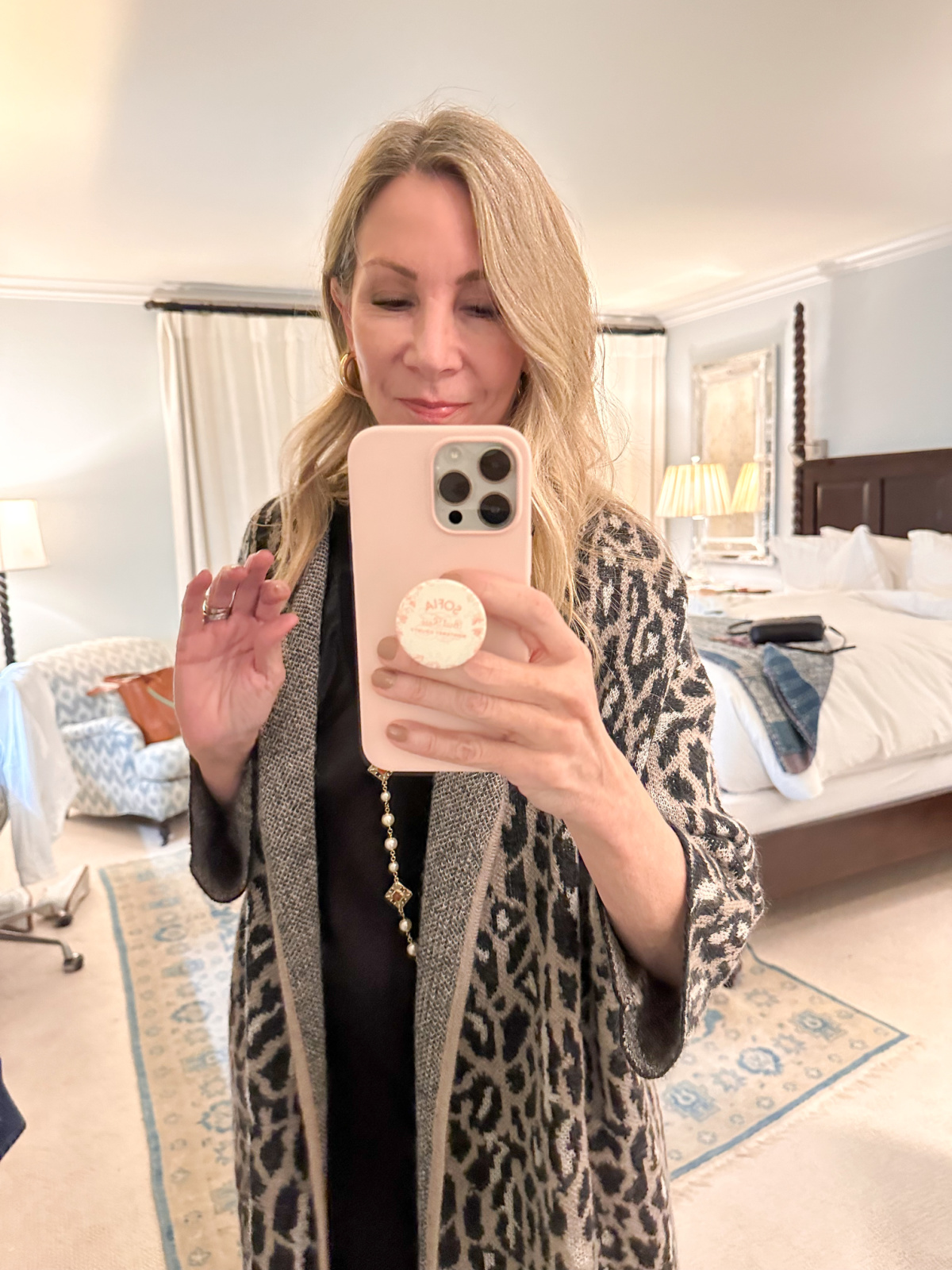 Woman taking mirror selfie.