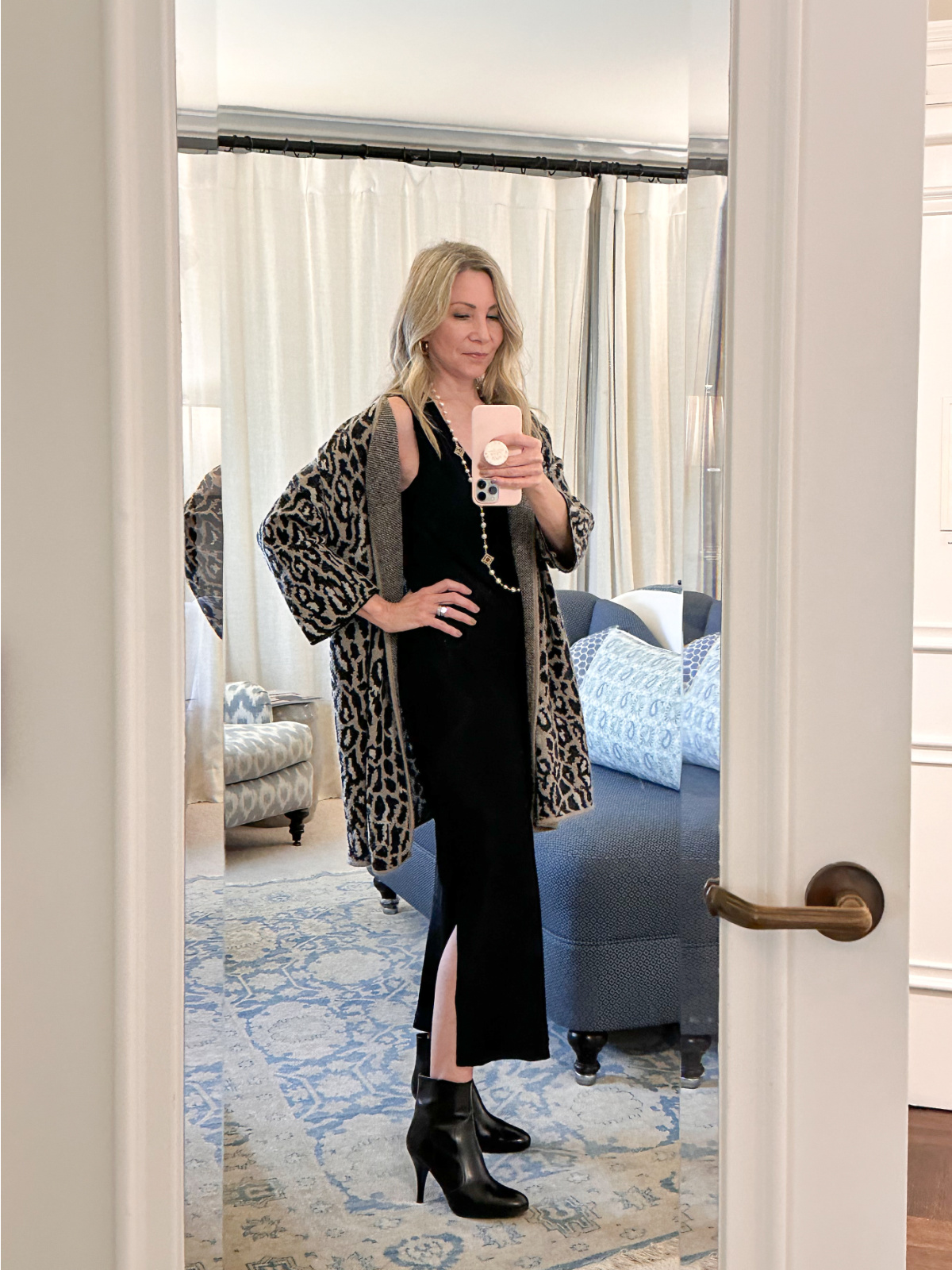 Woman taking mirror selfie.