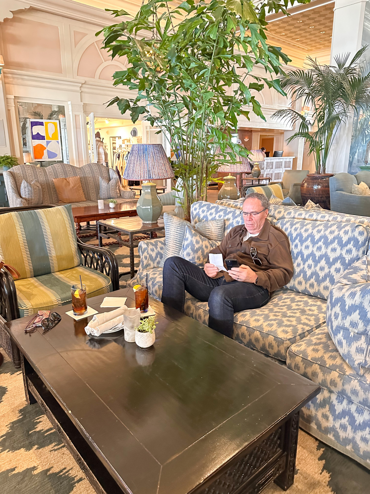 Man sitting on sofa in Casa Del Mar's Lobby Lounge.