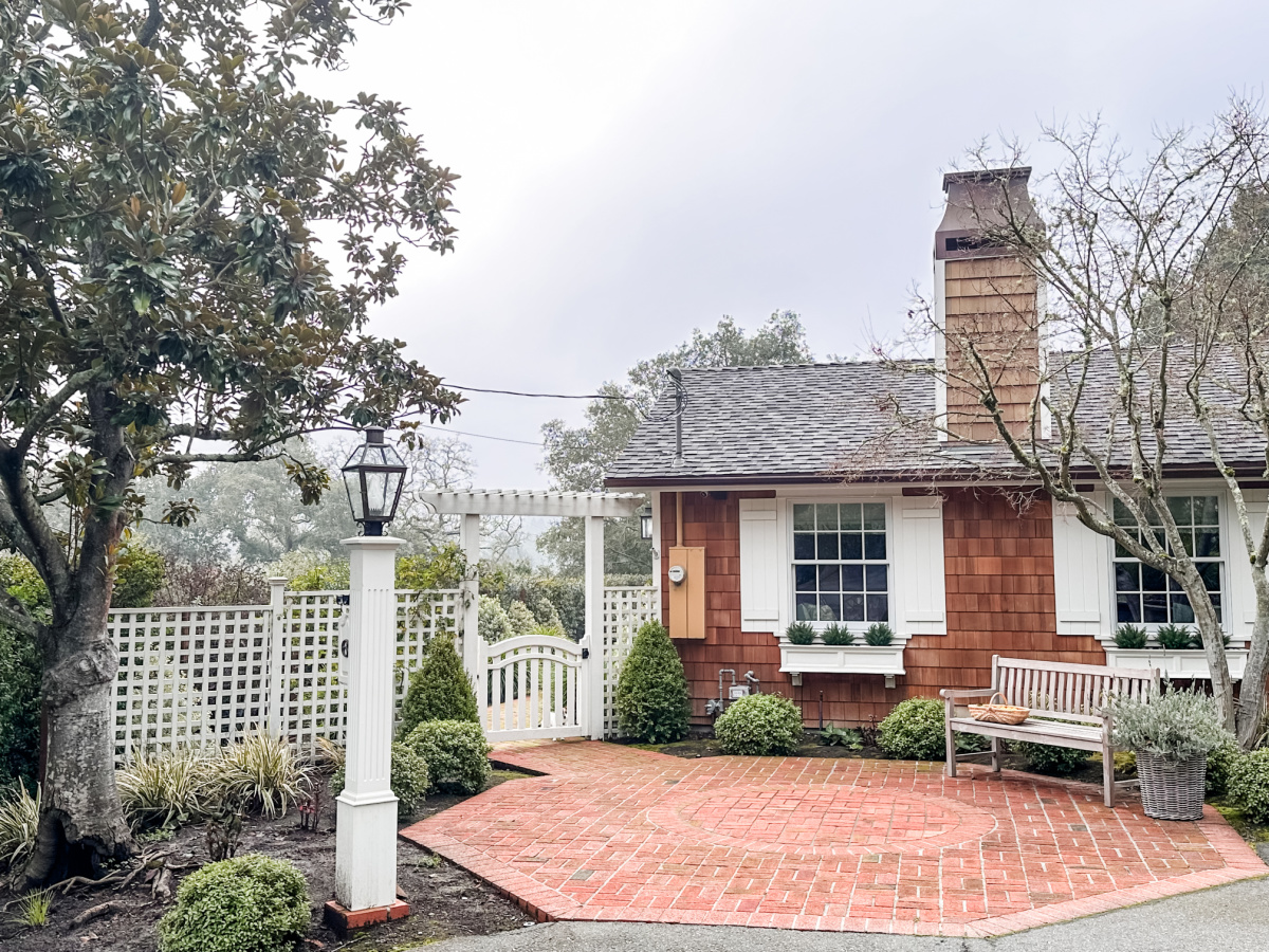 Exterior of shingled house in winter.