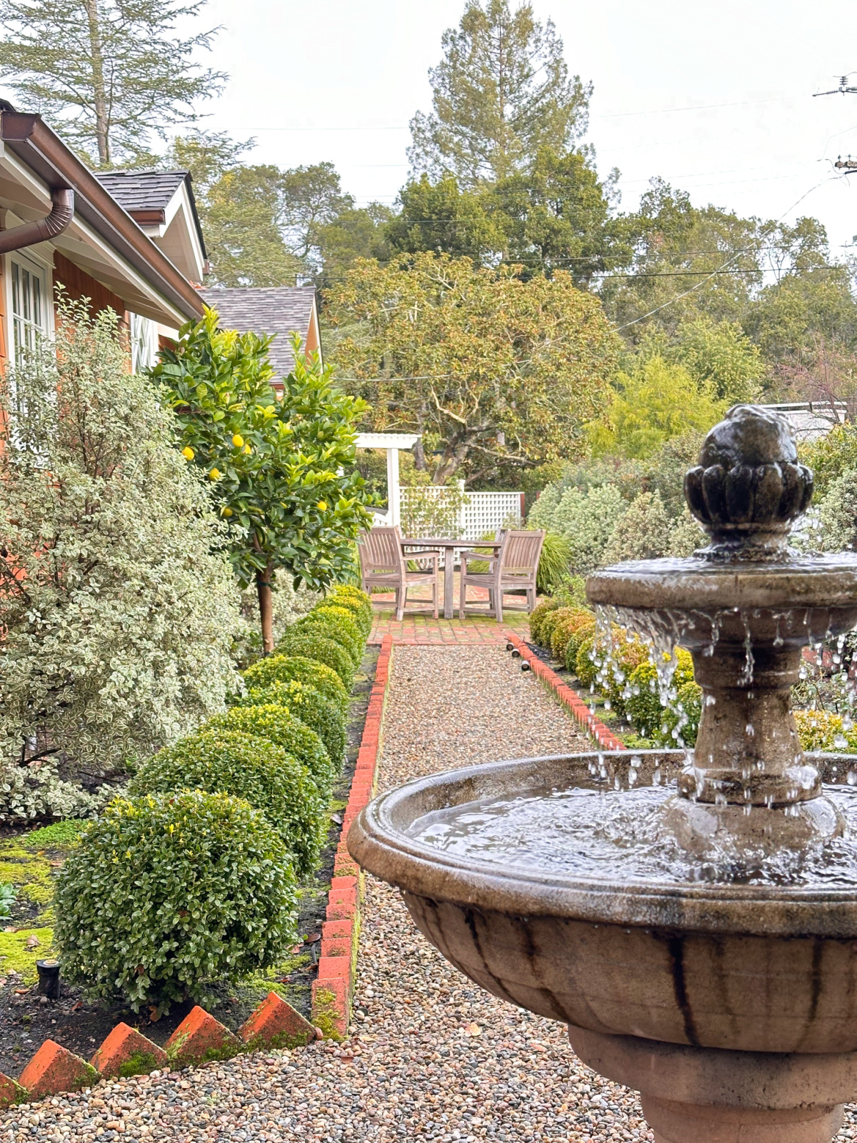 Fountain in front of garden path.