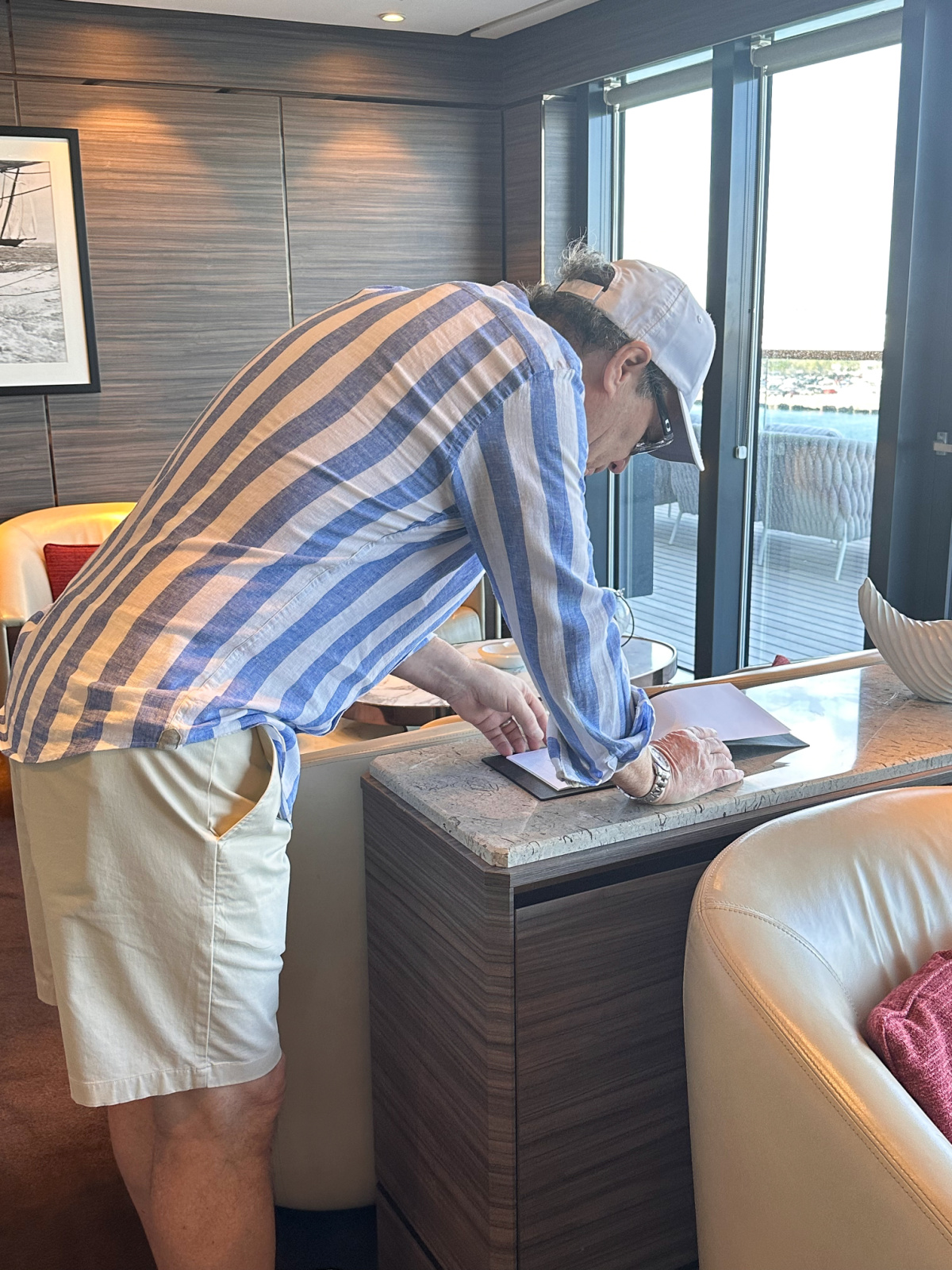Man looking at cigar menu on Evrima yacht.