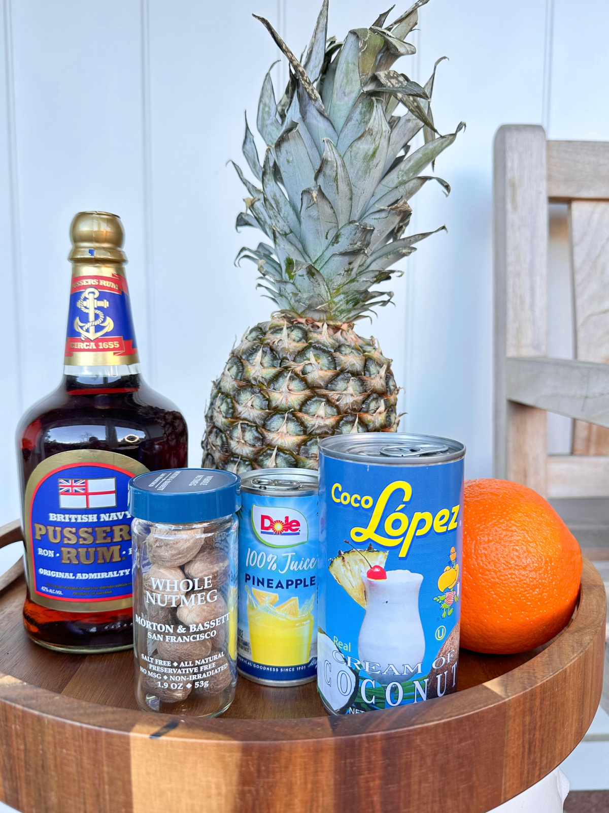Painkiller cocktail ingredients on a tray.