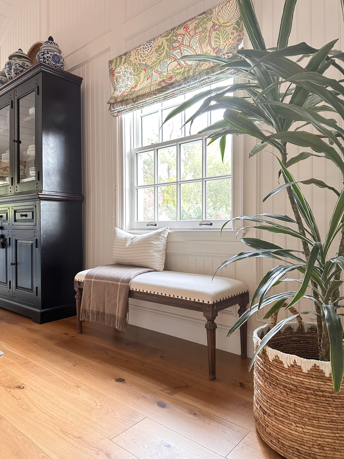 RH bench under window, next to black hutch in family room.