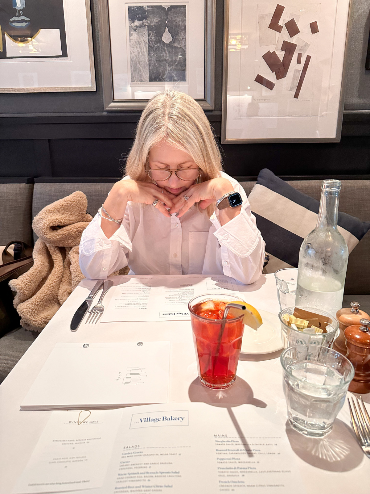 Woman scanning menu at The Village Bakery.