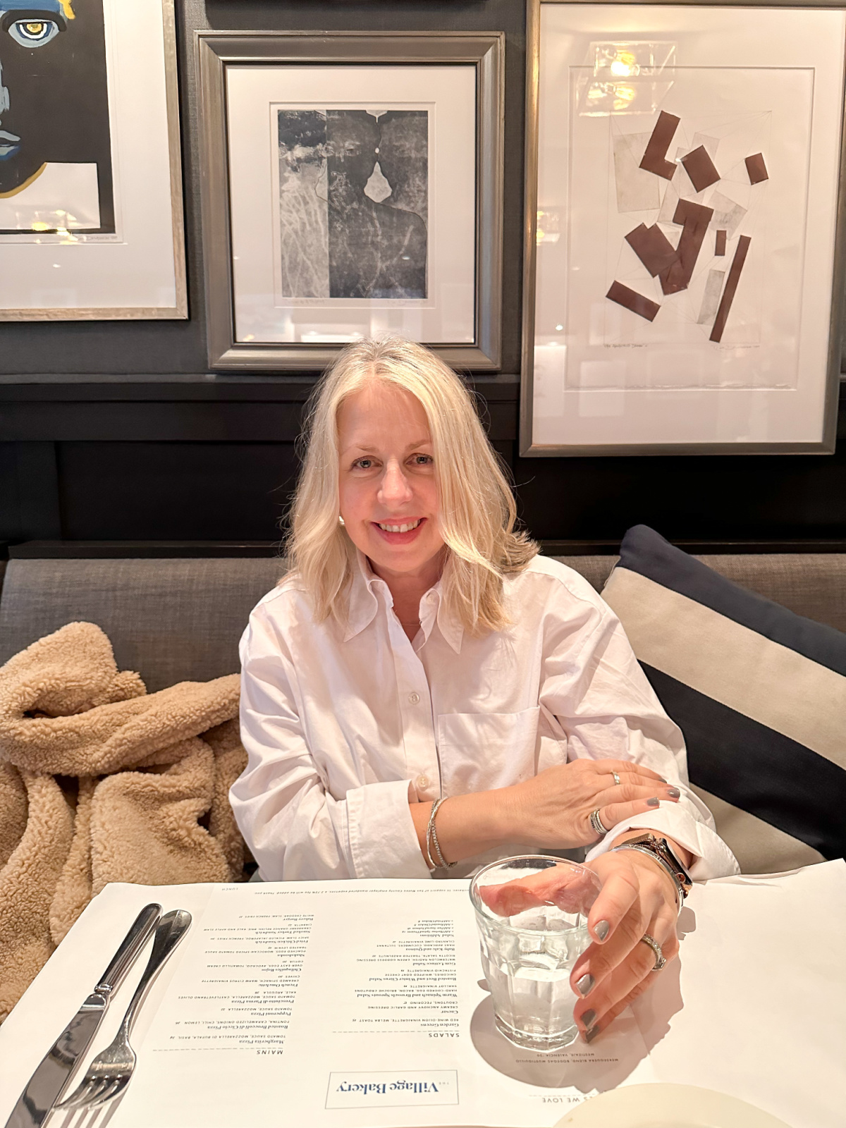 Woman sitting at table at The Village Bakery.