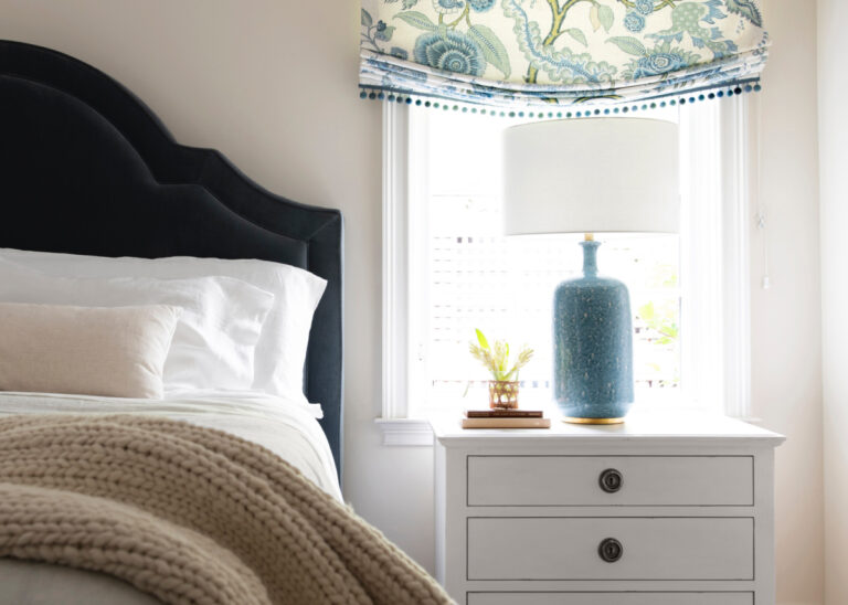 Bed and nightstand with table lamp.