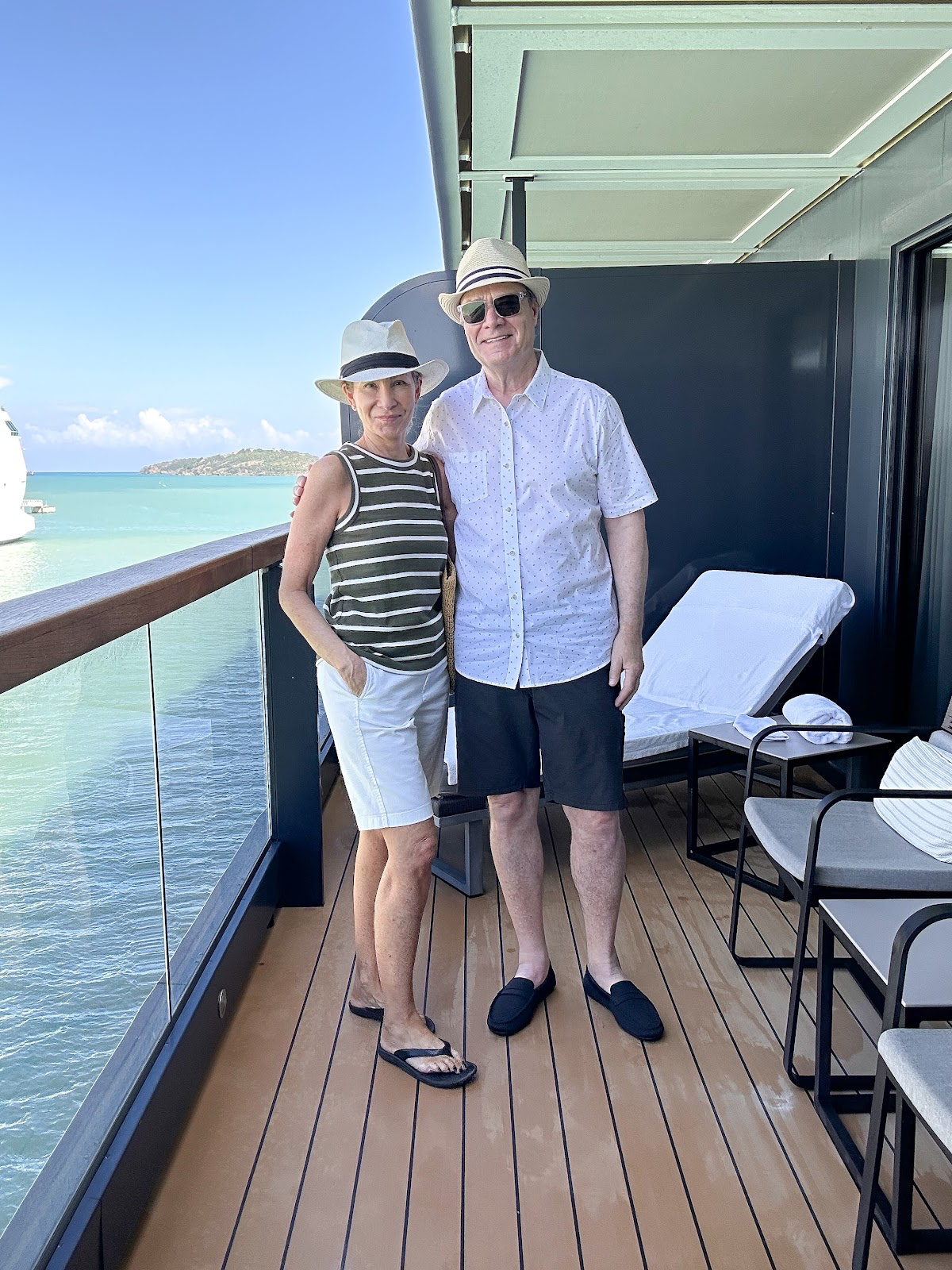 Couple standing on cruise ship terrace.