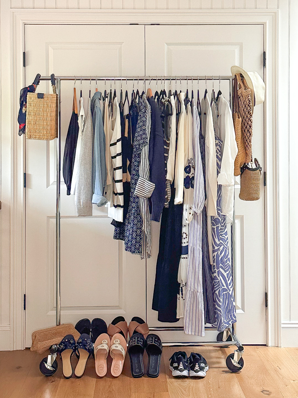 Rolling rack of clothes ready to be packed for Caribbean cruise.