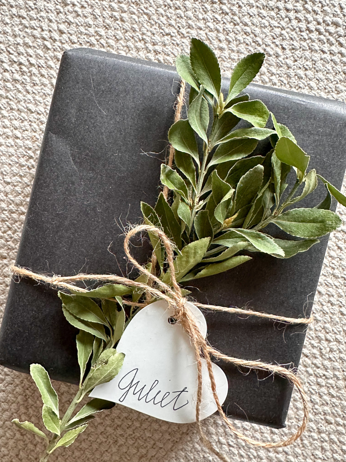 Wrapped gift on woven mat.