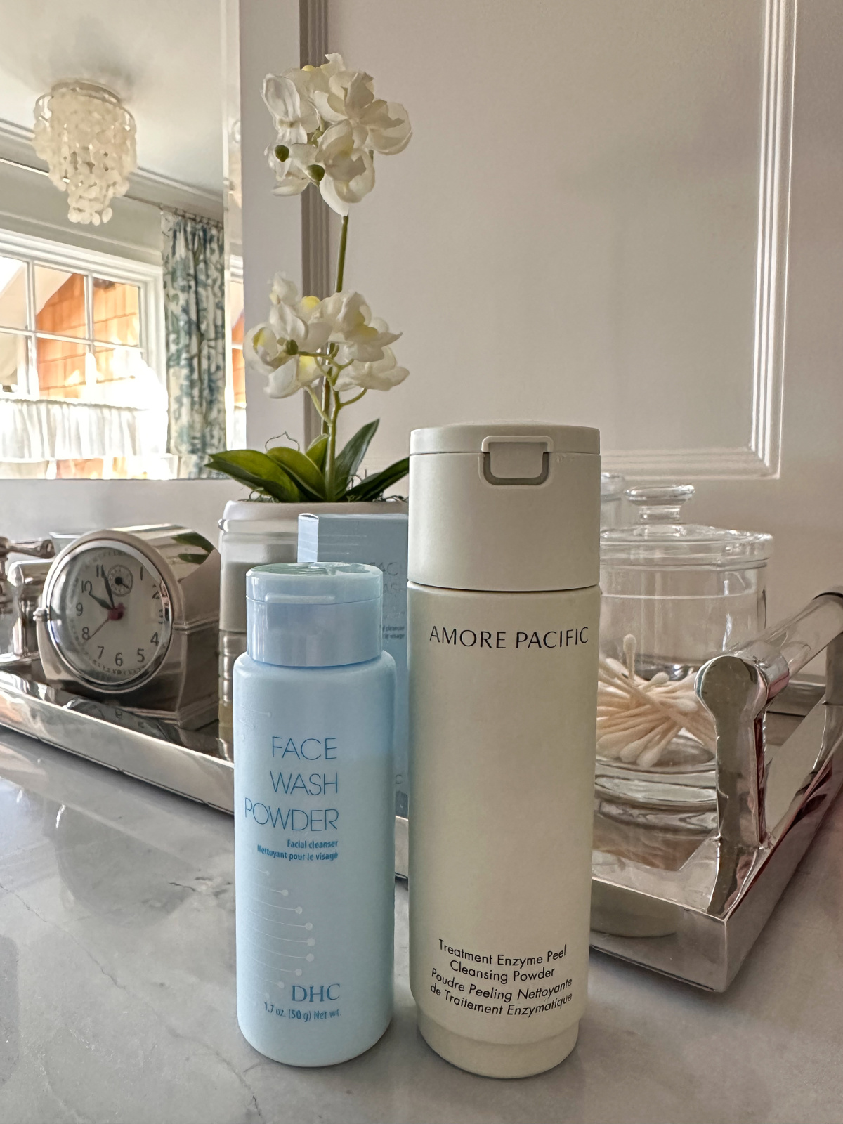 DHC and Amore Pacific facial cleansers on bathroom vanity.